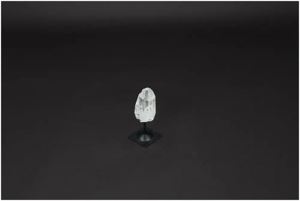 Lemurian Quartz on black metal stand, a powerful purification stone for harmonizing energy and neutralizing negative vibrations.
