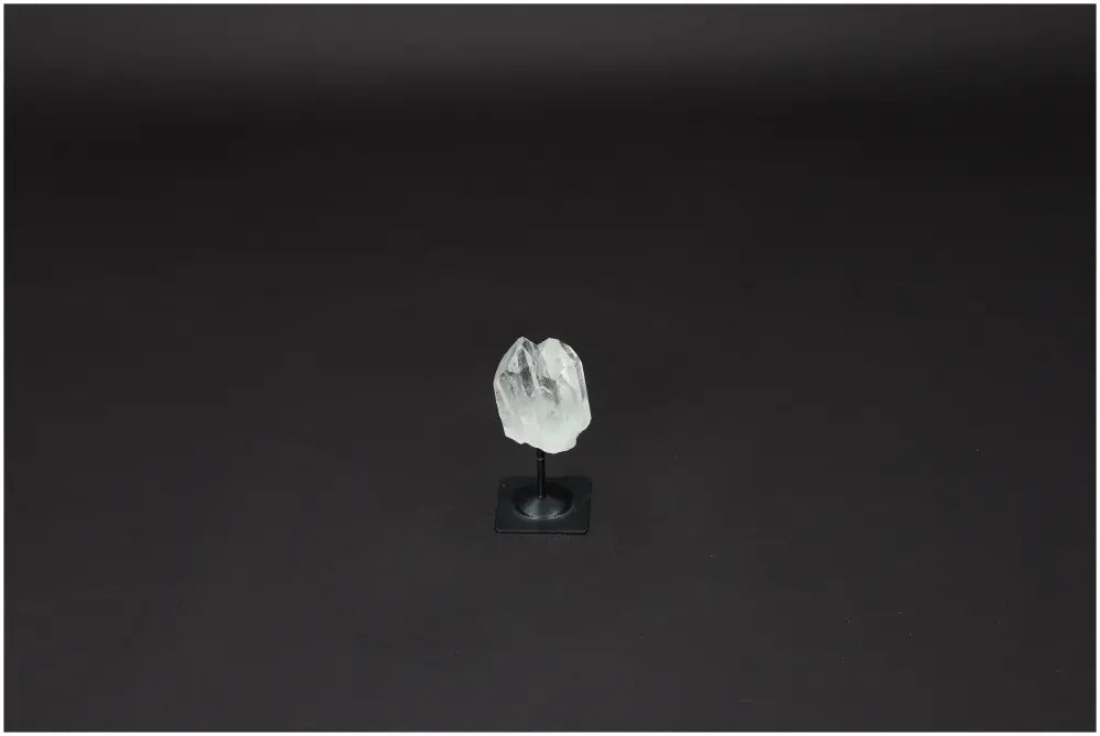 Lemurian Quartz crystal on metal stand against black background, ideal for purification and energy harmonizing.