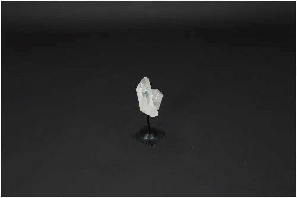 Lemurian Quartz crystal on sleek metal stand, ideal for purification and energy harmonization, against a dark background.