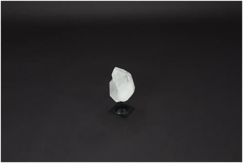 Lemurian Quartz on metal stand for energy purification and harmonization on dark background.
