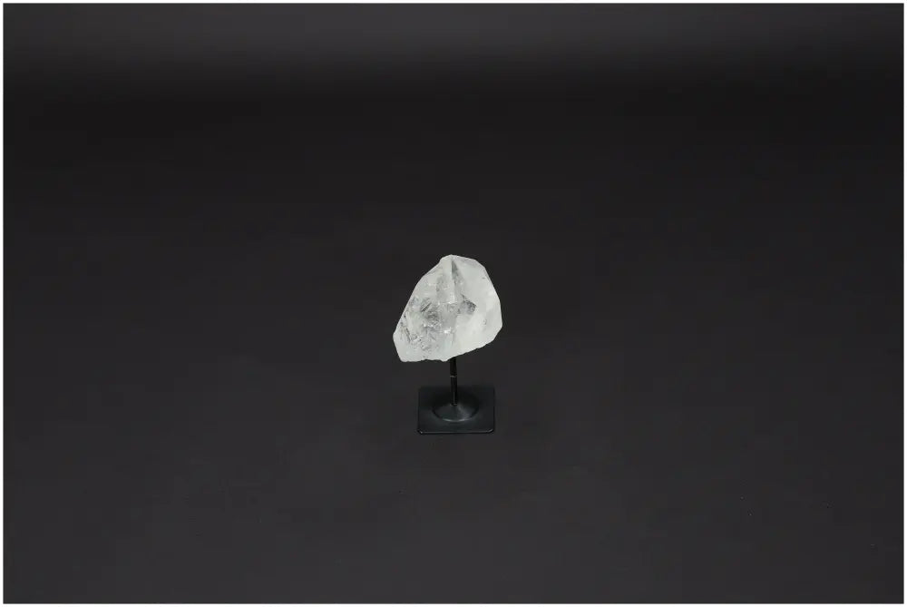 Lemurian Quartz Stone on Metal Stand, a clear quartz known for purification, negative energy neutralization, and electromagnetic protection.