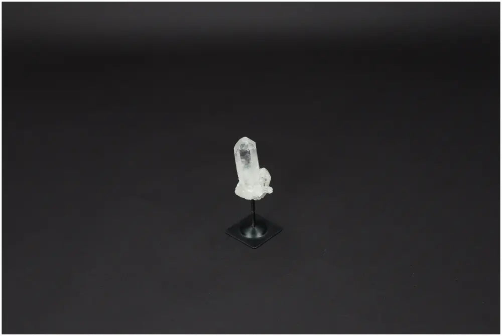 Lemurian Quartz crystal on a sleek metal stand, ideal for purification and harmonizing energy, against a dark background.