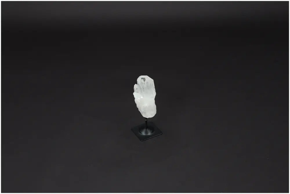 Lemurian Quartz crystal on metal stand, known for purification and harmonizing energy, ideal for neutralizing negative vibrations.