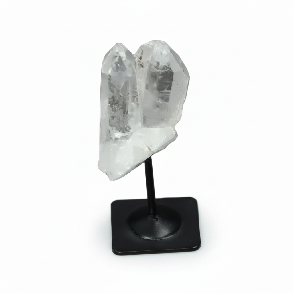 Lemurian Quartz on metal stand against dark background, showcasing clear quartz's purification qualities.