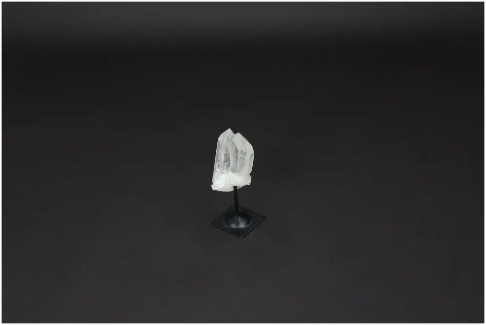 Lemurian Quartz crystal on elegant metal stand, ideal for purification and harmonizing energy, displayed on black background.