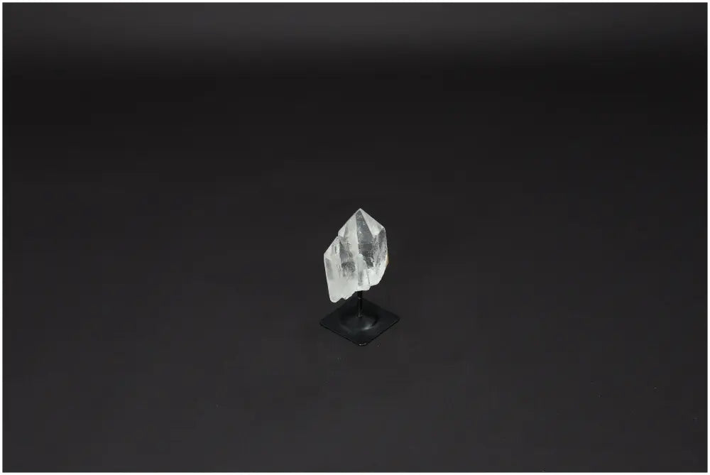 Lemurian Quartz on metal stand against dark background, ideal for purification, harmonizing energy, and neutralizing negative vibrations.