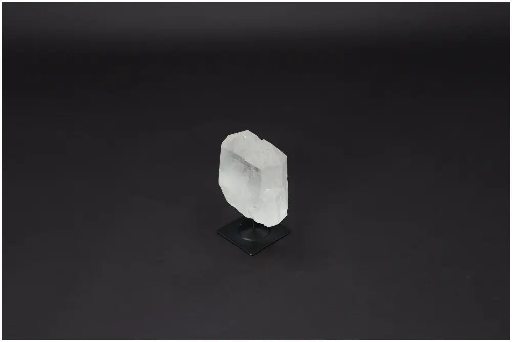 Lemurian Quartz on metal stand, a clear quartz crystal known for purification and harmonizing energy. Enhances space with positive vibrations.