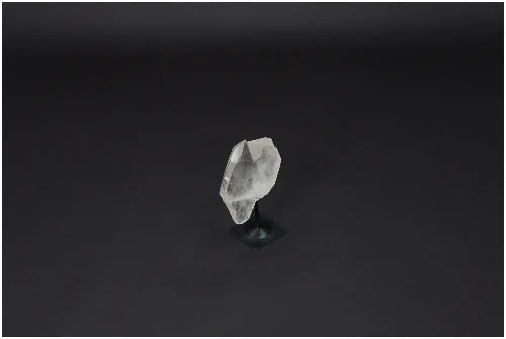 Lemurian Quartz stone on metal stand, known for its powerful purification and harmonizing properties with clear quartz benefits.