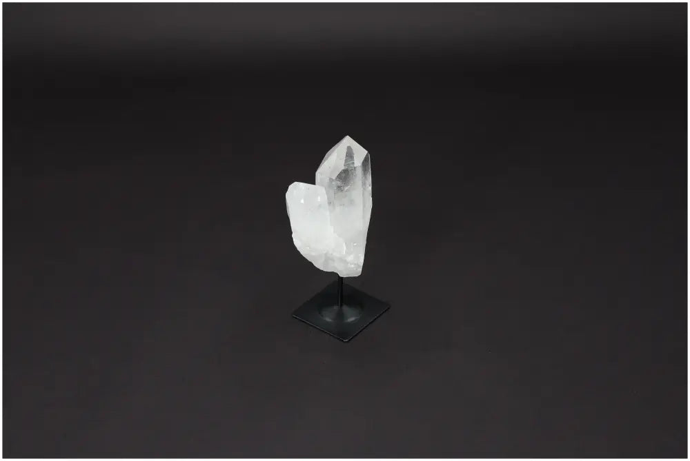 Lemurian Quartz on sleek metal stand against dark background, ideal for purification and harmonizing energy spaces.