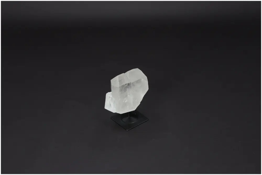 Lemurian Quartz on metal stand, powerful purification stone for harmonizing body, mind, and energy, absorbs negative vibrations.