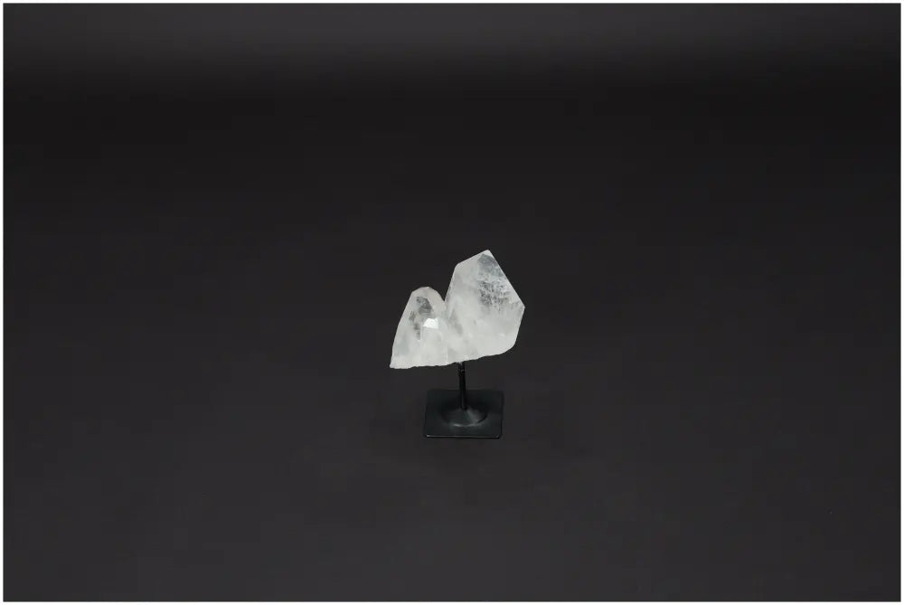 Lemurian Quartz Crystal on Metal Stand, a clear quartz stone known for energy purification and harmonizing abilities.