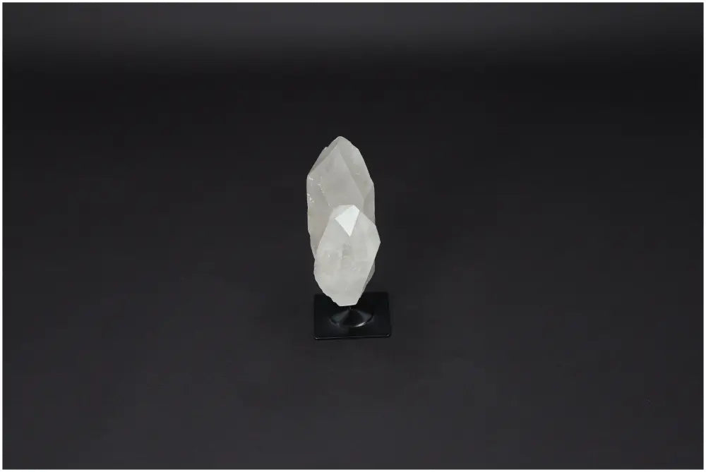 Lemurian Quartz on metal stand, a powerful clear quartz for purification and harmonizing energy, dispelling negative vibrations.