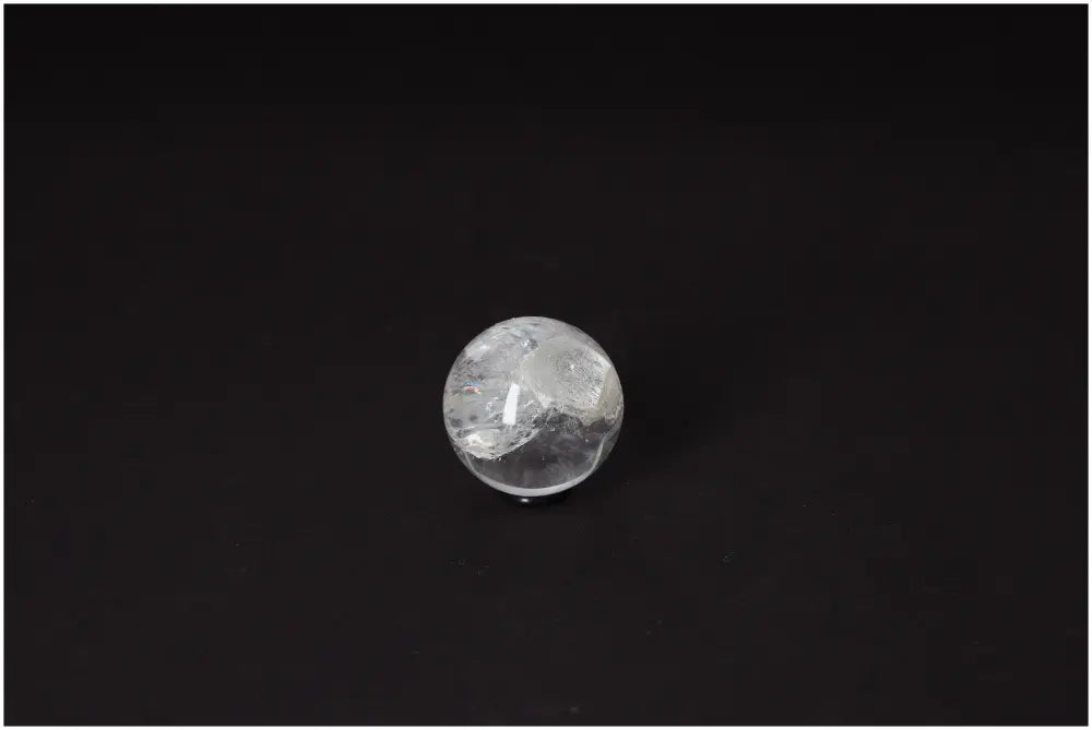 Lemurian Quartz Sphere 3-4 CM on dark background, showcasing its luminous clarity and ancient wisdom energy for spiritual growth.