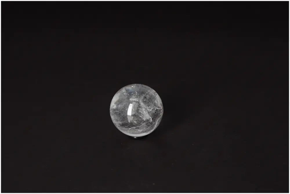 Lemurian Quartz Sphere 4-5 CM on dark background, showcasing its luminous clarity and radiance.