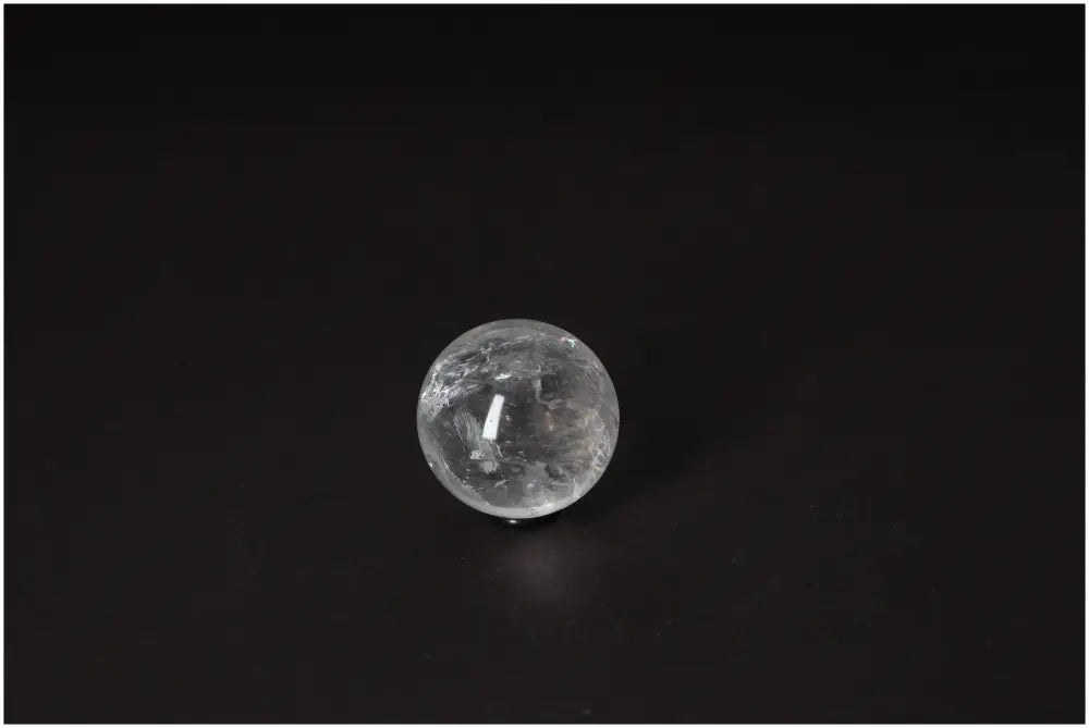 Lemurian Quartz Sphere 4-5 CM displaying radiant energy and ancient wisdom on a dark background.