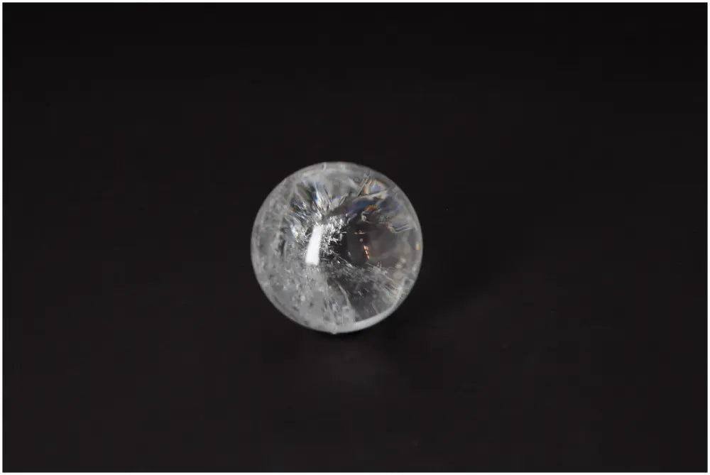 Lemurian Quartz Sphere 5-6 CM with radiant energy and luminous clarity on a dark backdrop, promoting spiritual growth and intuition.