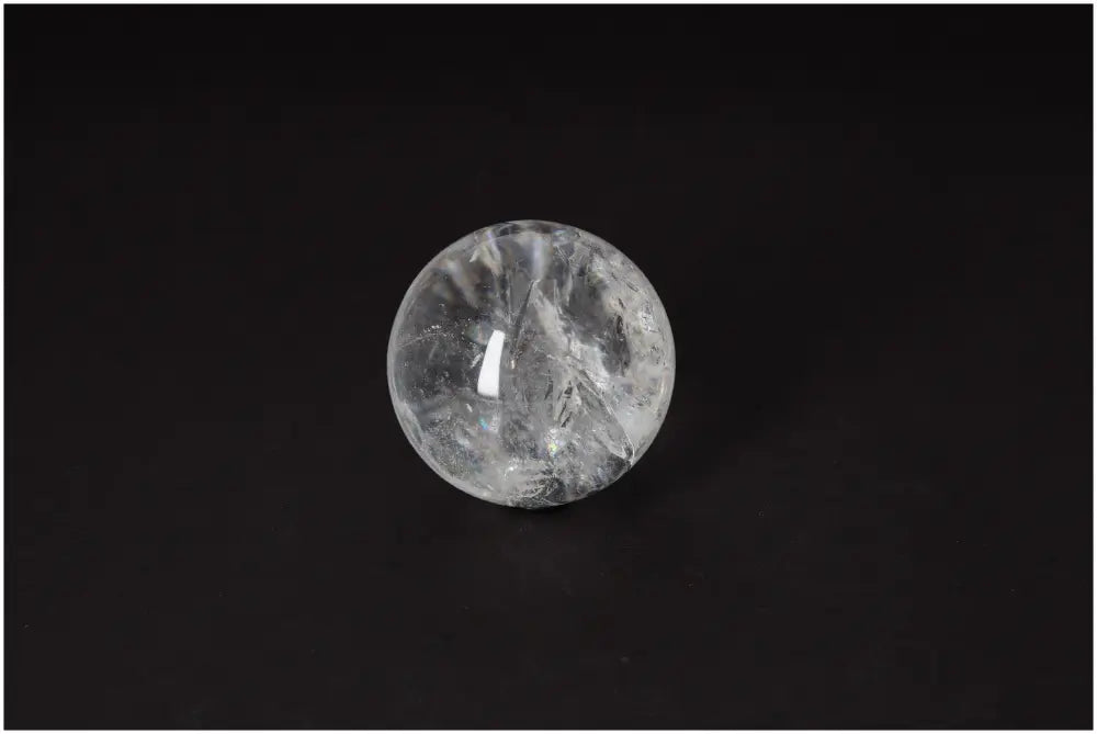Lemurian Quartz Sphere 6-7 CM displaying radiant clarity and ancient energy on a dark background.