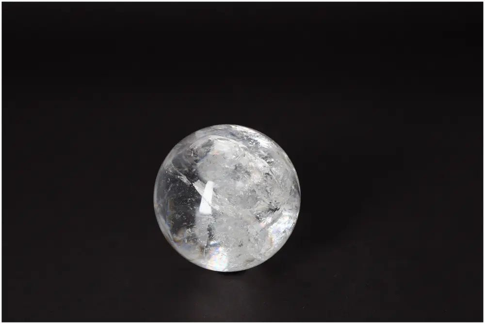 Lemurian Quartz Sphere 7-8 CM showcasing clarity and radiant energy on a dark background.