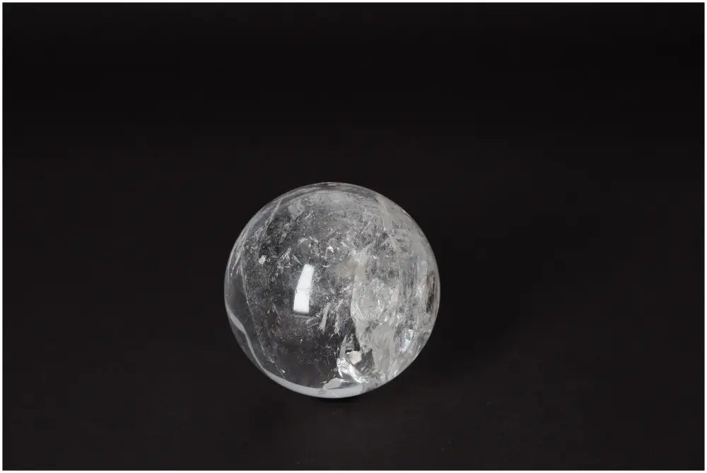 Lemurian Quartz Sphere 7-8 CM showcasing radiant energy and luminous clarity against a dark background.
