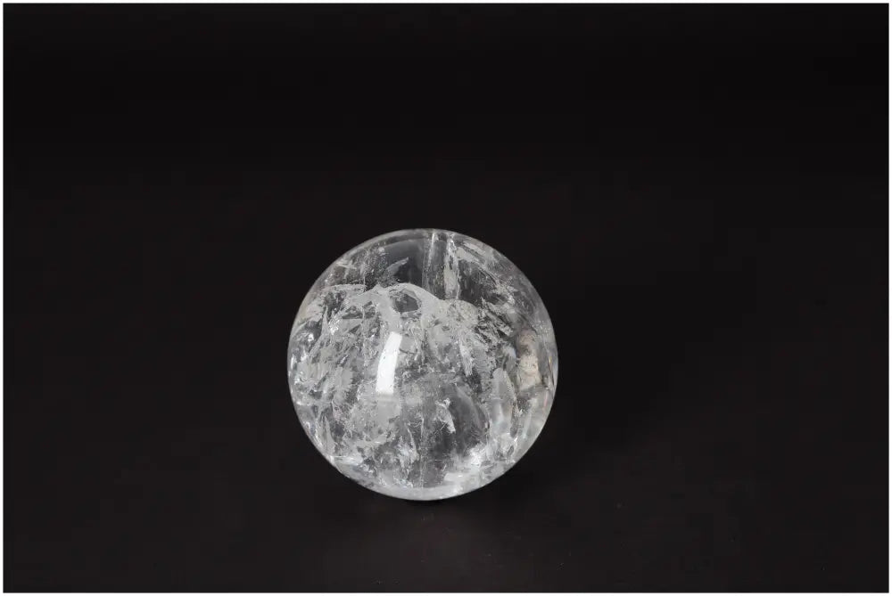 Lemurian Quartz Sphere 7-8 CM with radiant energy, known for spiritual growth and intuitive wisdom, on a dark background.