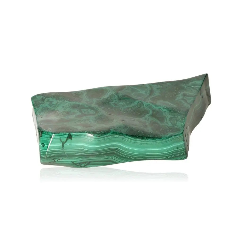 Smooth malachite stone showcasing vibrant green hues and unique patterns, symbolizing tranquility and transformation.