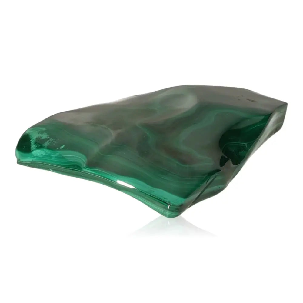 Polished malachite stone showcasing vibrant green hues and natural patterns, known for its soothing energy and transformative power.