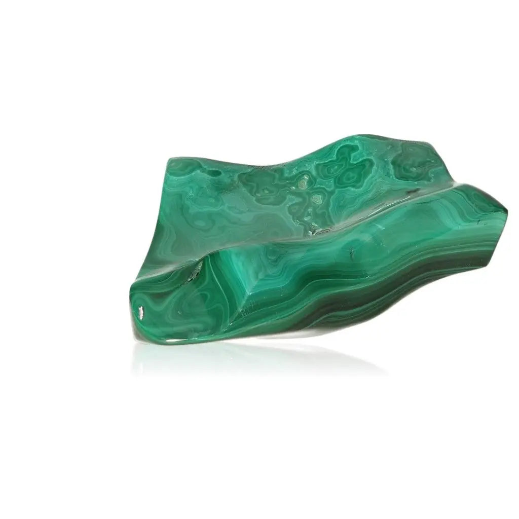 Vibrant green malachite gemstone showcasing its unique patterns and soothing energy, known for courage and positivity.