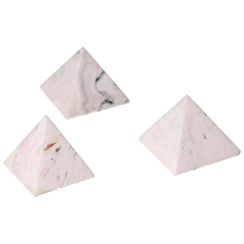 Manganocalcite pyramids with soothing pink tones for healing and creativity boost, promoting peace and calm energy.