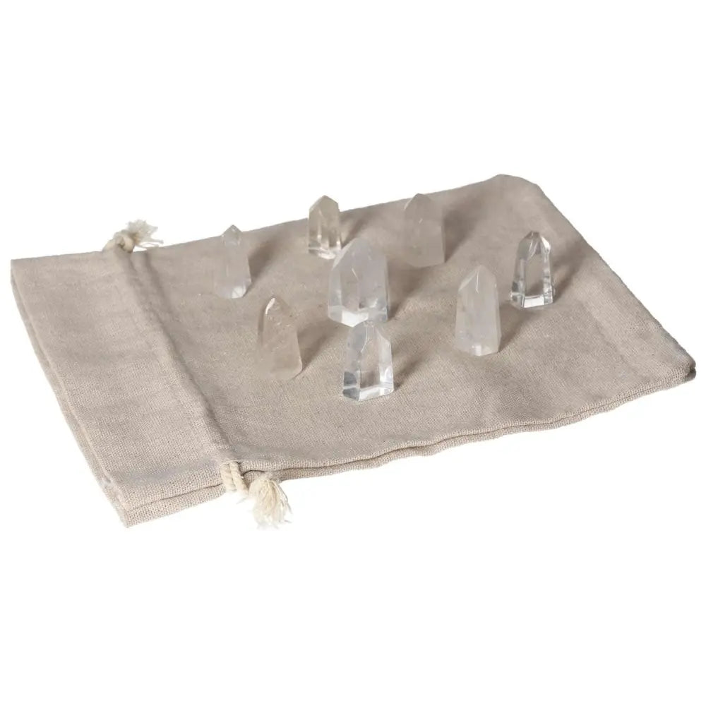 Mini clear quartz points on beige cloth, energy amplifiers for daily use, enhance focus and spiritual growth, must-have crystals.