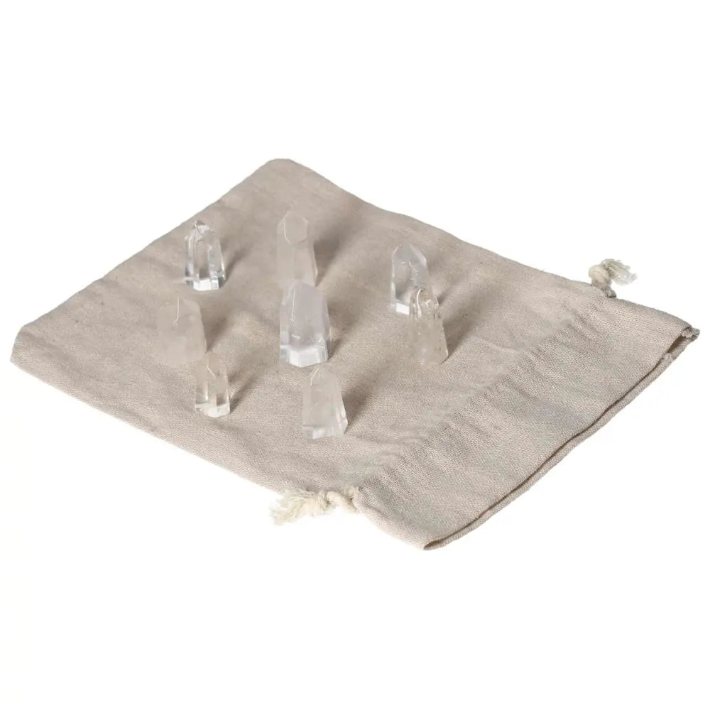 Collection of mini clear quartz points on a cloth bag, perfect for energy amplification and spiritual growth.
