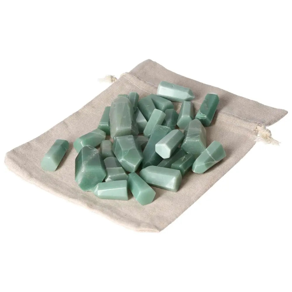 Mini Point Green Quartz crystals on beige fabric bag, ideal for healing and spiritual practices.