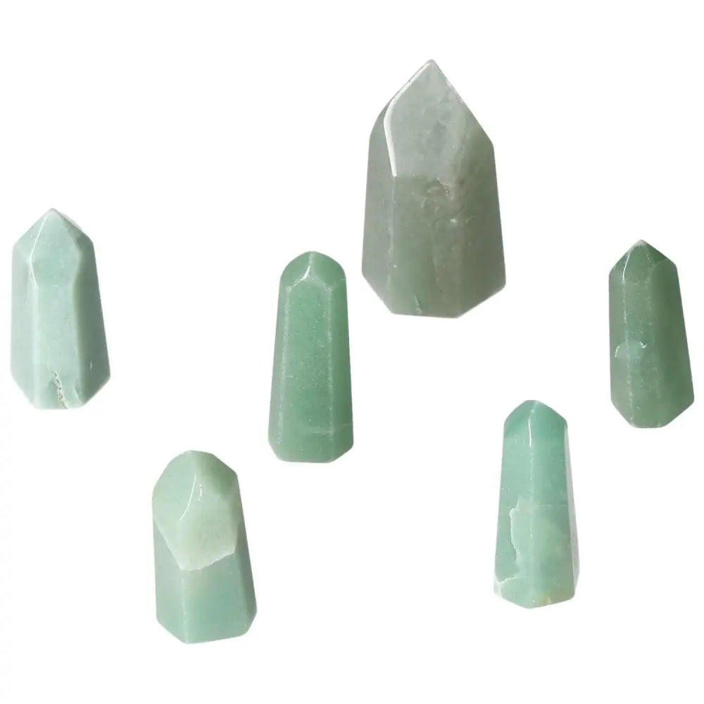Collection of six mini green quartz crystal points displayed on a white background.