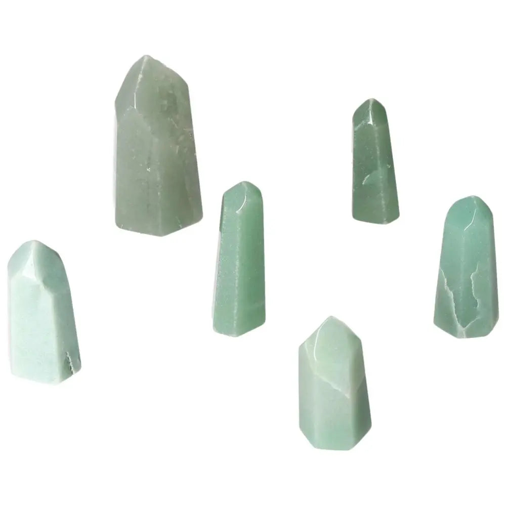Collection of mini point green quartz crystals in various sizes on a white background.