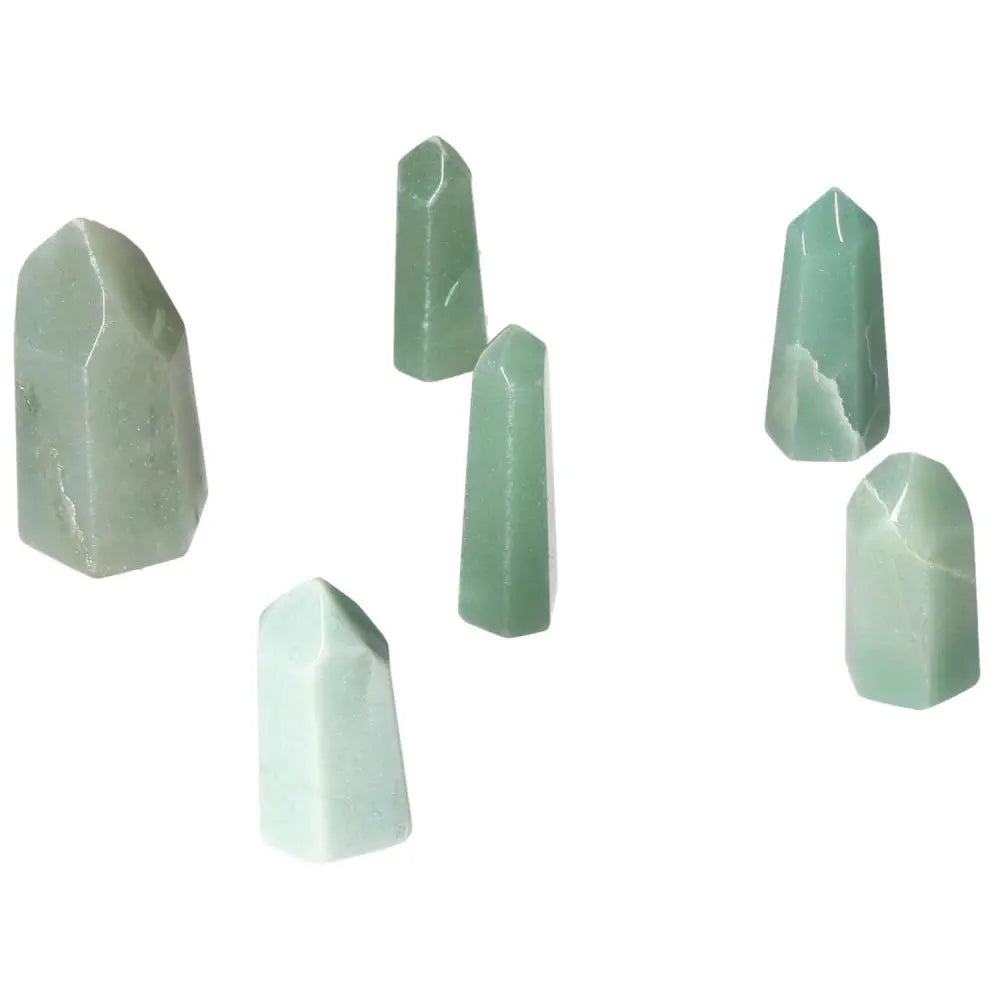 Collection of mini point green quartz crystals displayed on a white background.