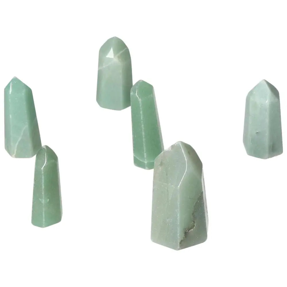 Collection of mini green quartz crystal points displayed on a white background.