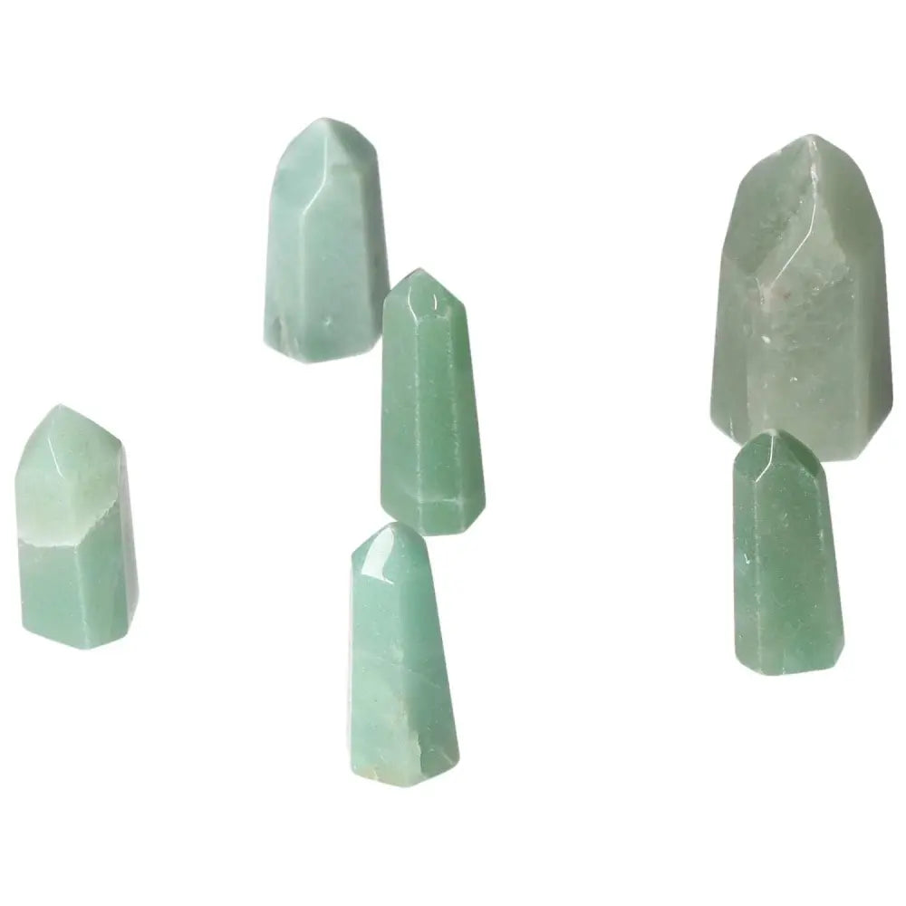 Mini point green quartz crystals on white background