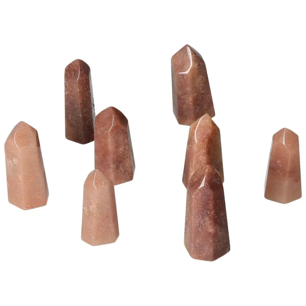 Mini Red Quartz Points for vitality and courage, featuring energizing red tones from hematite inclusions, ideal for grounding energy.