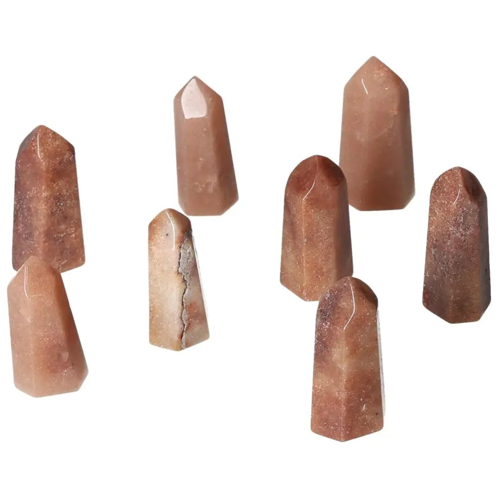 Mini Red Quartz Points showcasing vibrant red tones, ideal for vitality, courage, and grounding energy. Includes natural hematite inclusions.