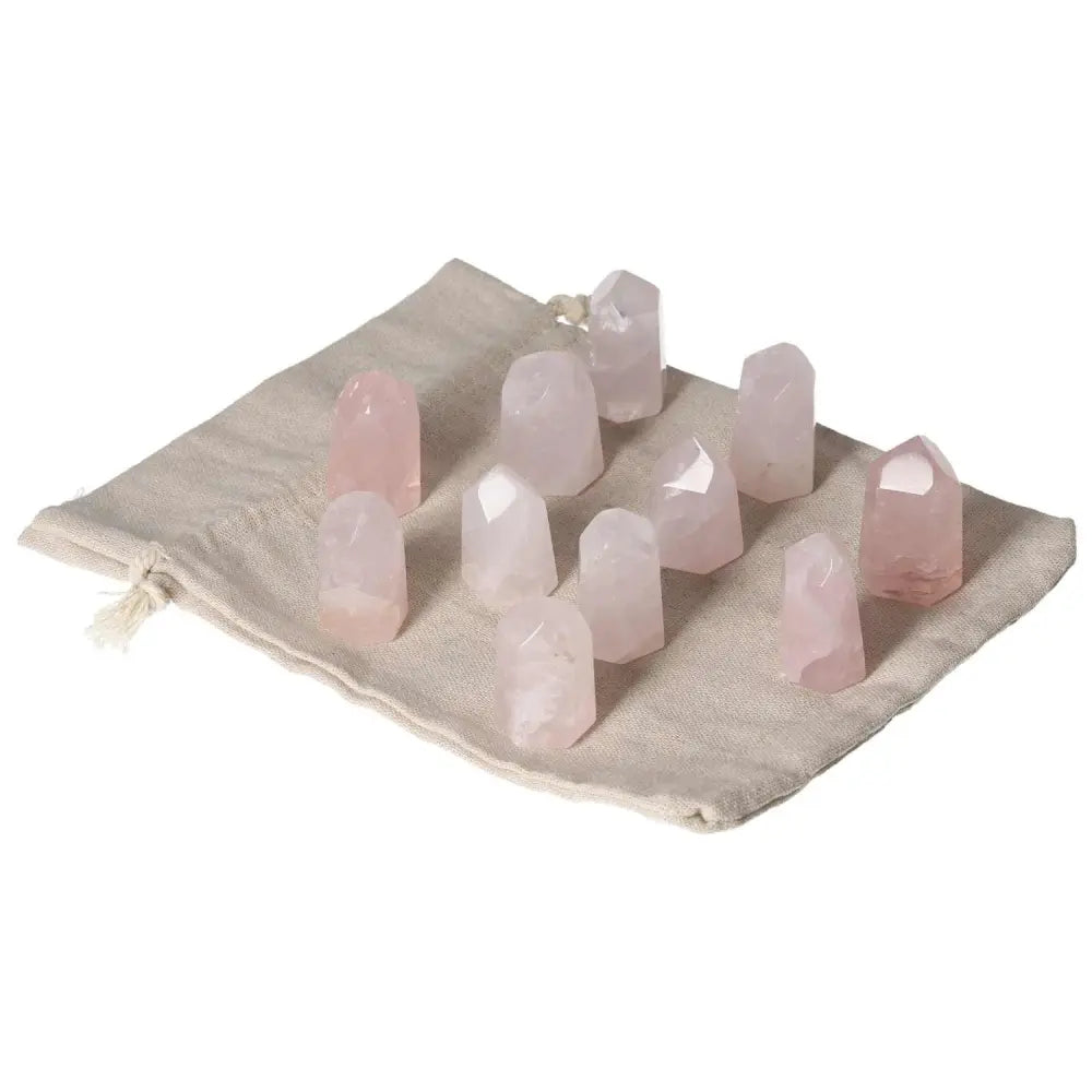 Mini Rose Quartz points on fabric pouch, ideal for promoting love and heart healing, compact for pocket use and supporting emotional balance.