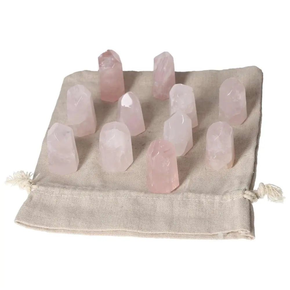 Mini Rose Quartz Points on beige pouch for love, compassion, and heart healing; ideal for promoting emotional balance and inner peace.
