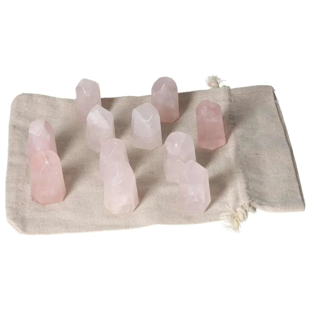 Mini Rose Quartz points on cloth, promoting love and emotional healing; ideal for heart chakra and personal use.