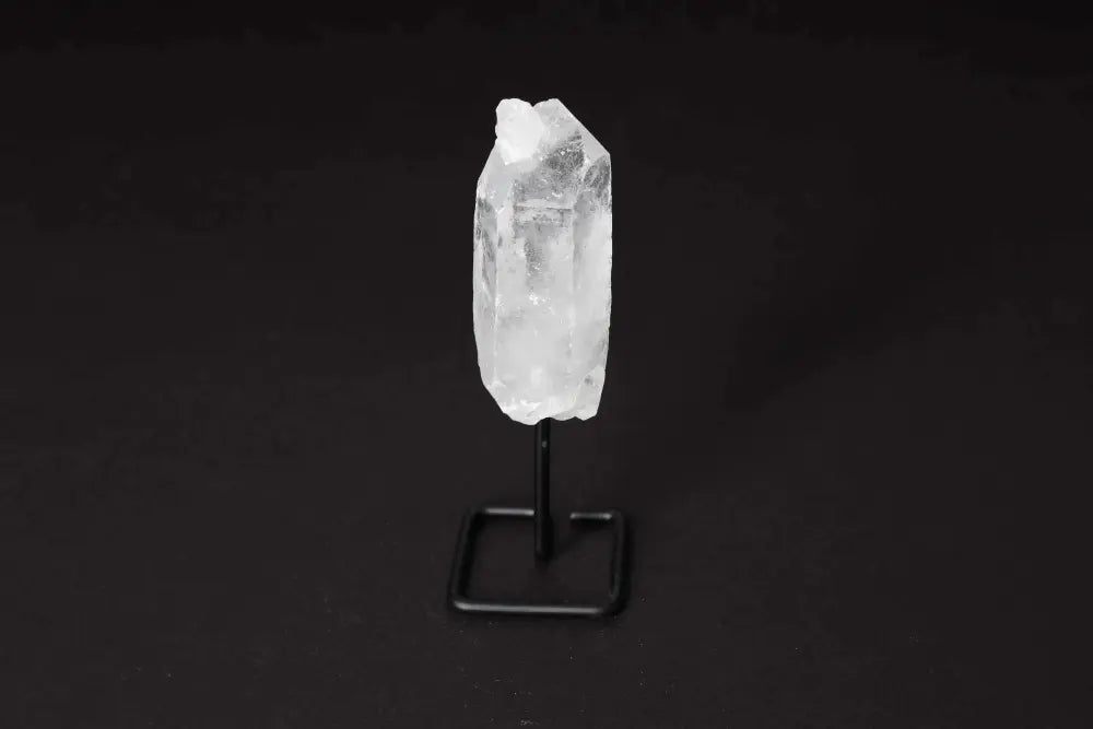 Natural Clear Quartz Point on black stand for energy amplification and clarity.
