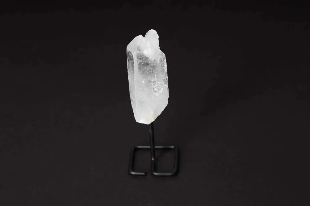 Natural Clear Quartz Point on stand for energy amplification and alignment, ideal for meditation and manifestation.