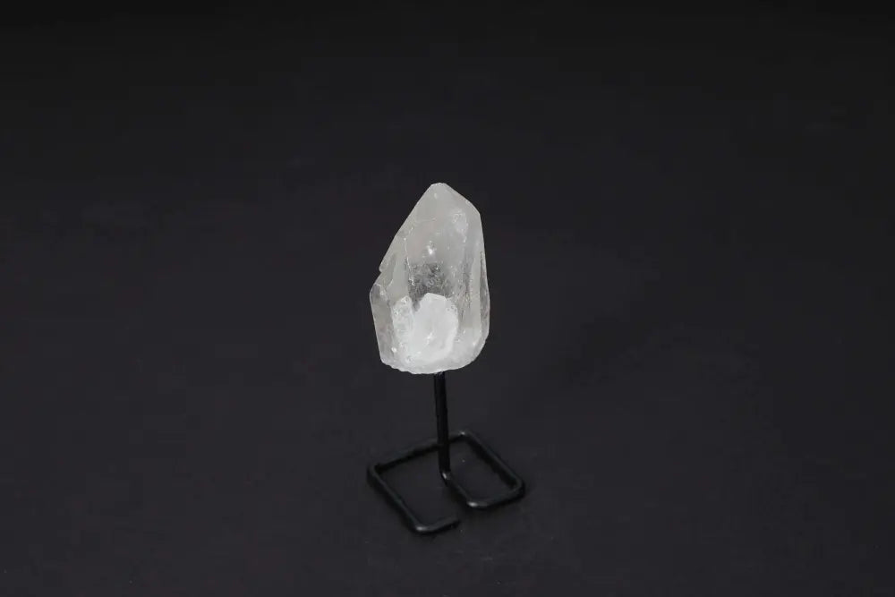 Natural Clear Quartz Point on modern stand for energy amplification, clarity, and meditation, enhancing any space with elegance.