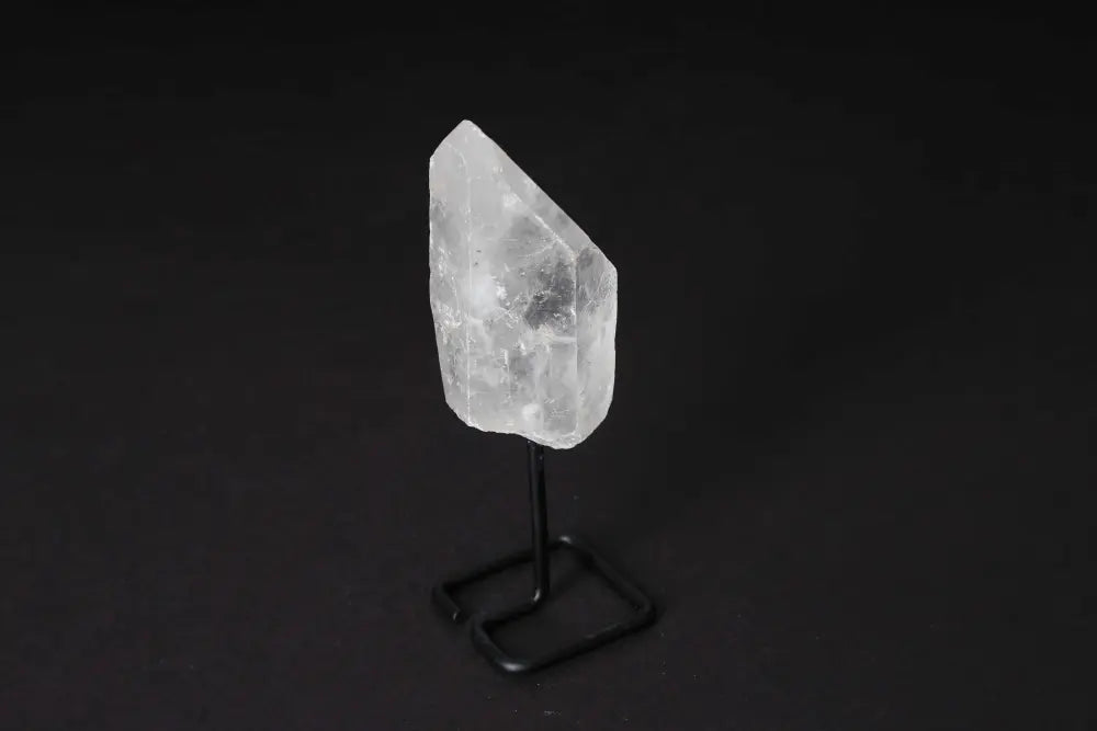 Natural Clear Quartz Point on modern stand for energy amplification and meditation.