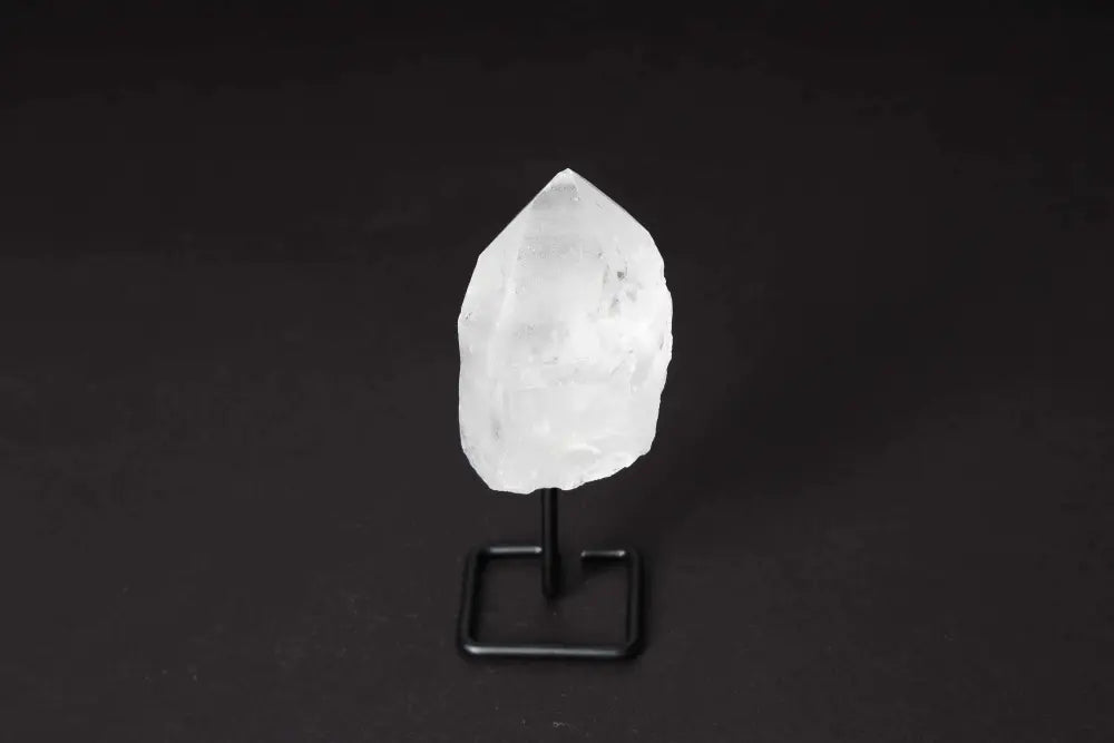 Natural clear quartz point on a modern stand, known as a Master Healer, amplifying energy for meditation and clarity.