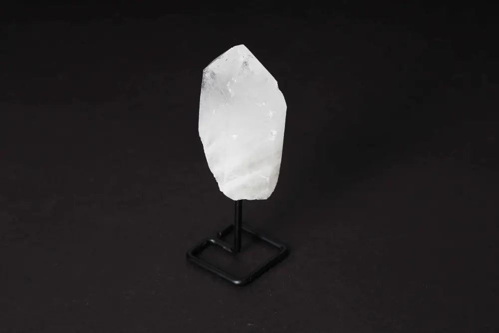 Natural Clear Quartz Point on modern stand, ideal for meditation and energy work, amplifying clarity and intention in any space.