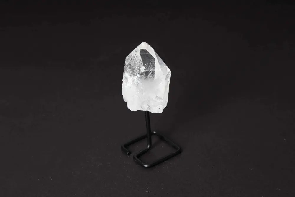 Natural clear quartz point on modern stand, ideal for meditation, energy work, and manifestation, amplifying clarity and focus.