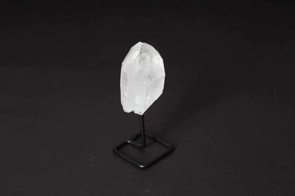 Natural Clear Quartz Point on Stand for energy amplification and clarity, ideal for meditation and aligning spaces with refined elegance.