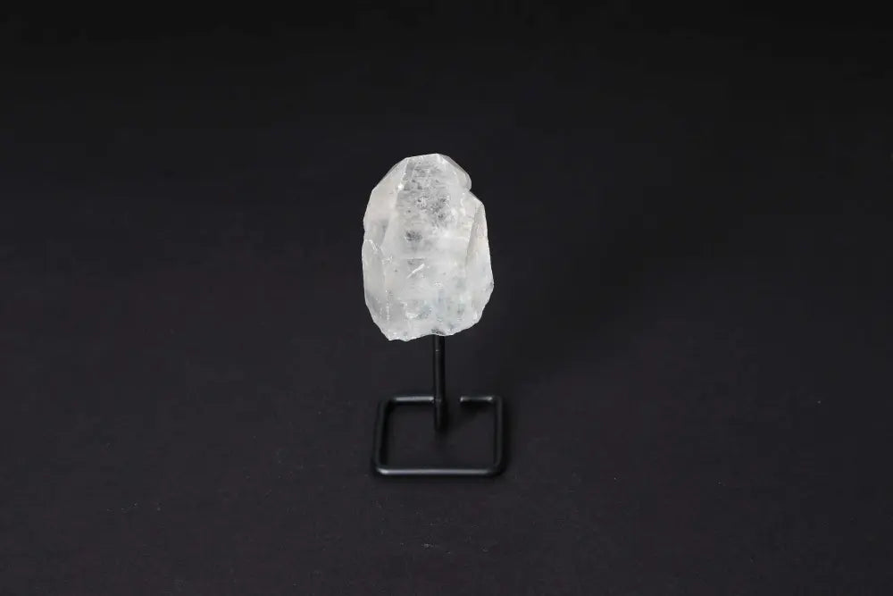Natural Clear Quartz Point on modern stand, known as the Master Healer, enhances energy and clarity in meditation and energy work.